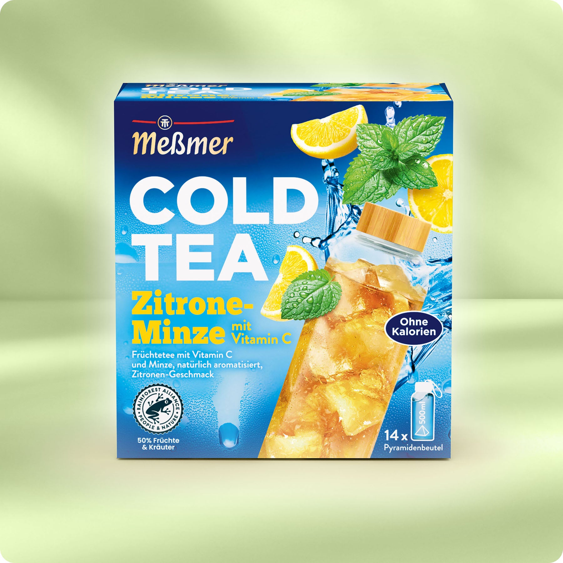 Eine Schachtel Meßmer DE Cold Tea Zitrone-Minze, mit Abbildungen von Zitronenscheiben, Minzblättern und Eistee. Die Verpackung hebt Vitamin C und null Kalorien hervor und verspricht eine gesunde Erfrischung.