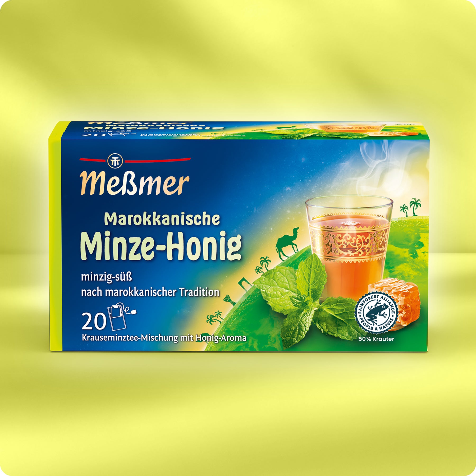 Eine Schachtel Meßmer DE Marokkanische Minze-Honig zeigt Minzblätter, Honigwaben und ein Teeglas auf einem gelben Hintergrund mit Kamel- und Palmensilhouetten.